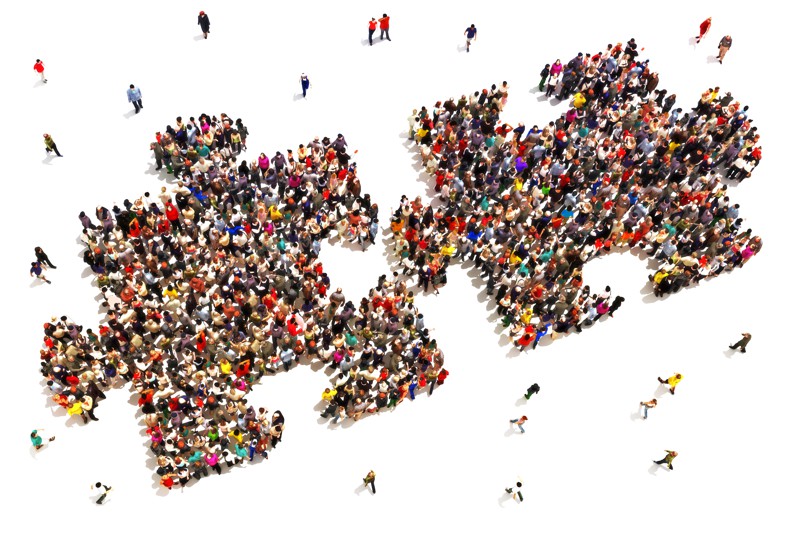 Image of people separating into puzzle shaped pieces